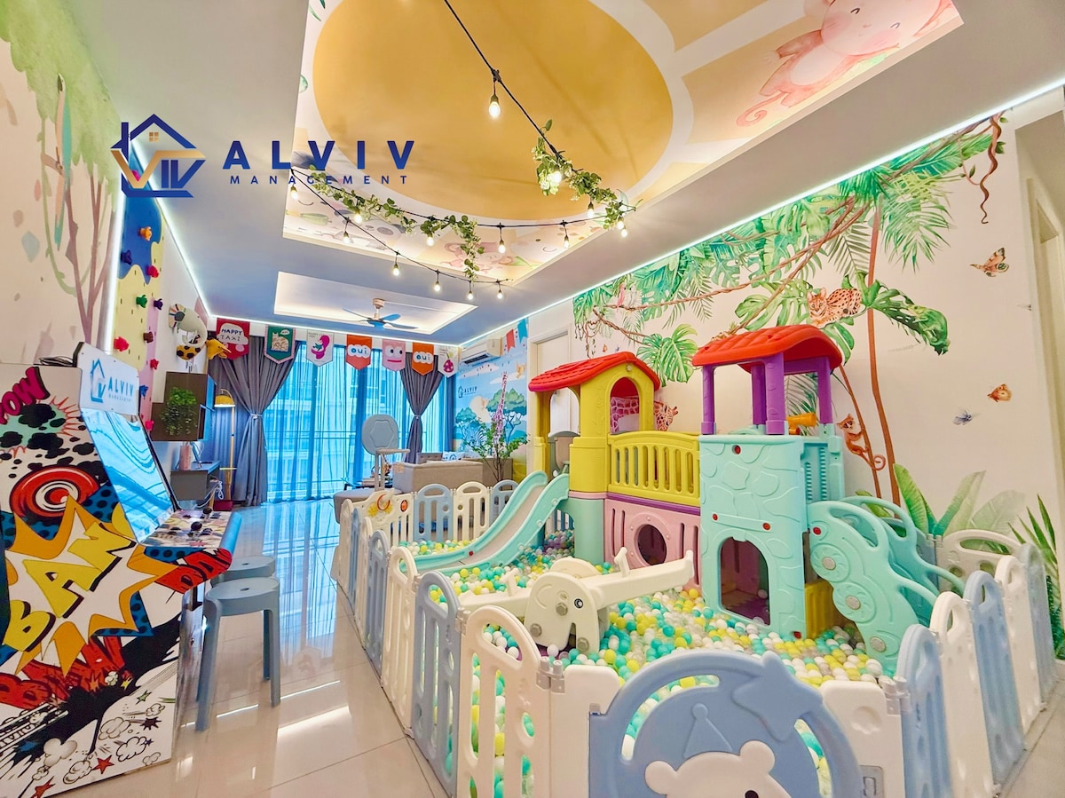 A vibrant play area is showcased, featuring a colorful playground structure alongside a ball pit enclosed by safety gates. The walls are adorned with playful murals of nature, and soft, diffused lighting creates an inviting ambiance for children and families.