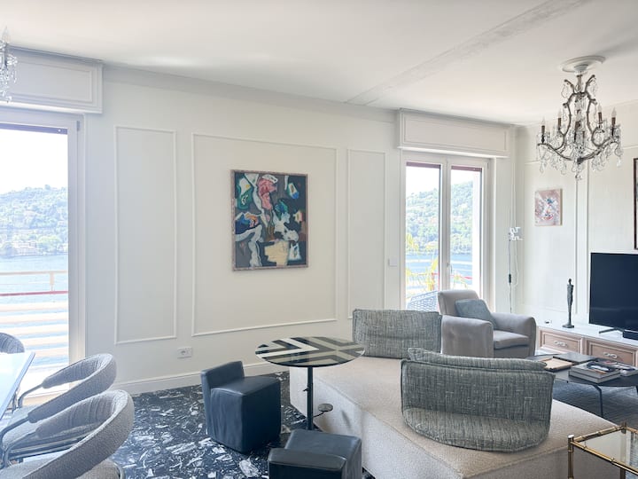 Spacious dining / living room with designer sofa.