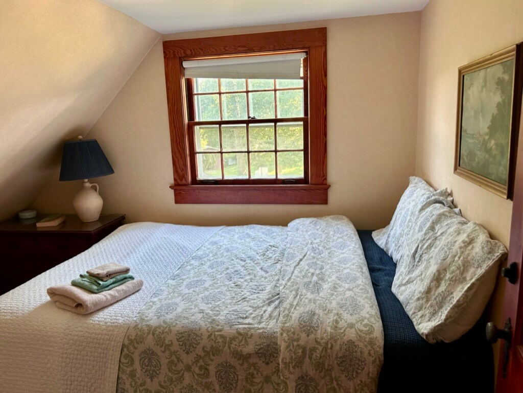 Upstairs guest bedroom, double bed, dresser.