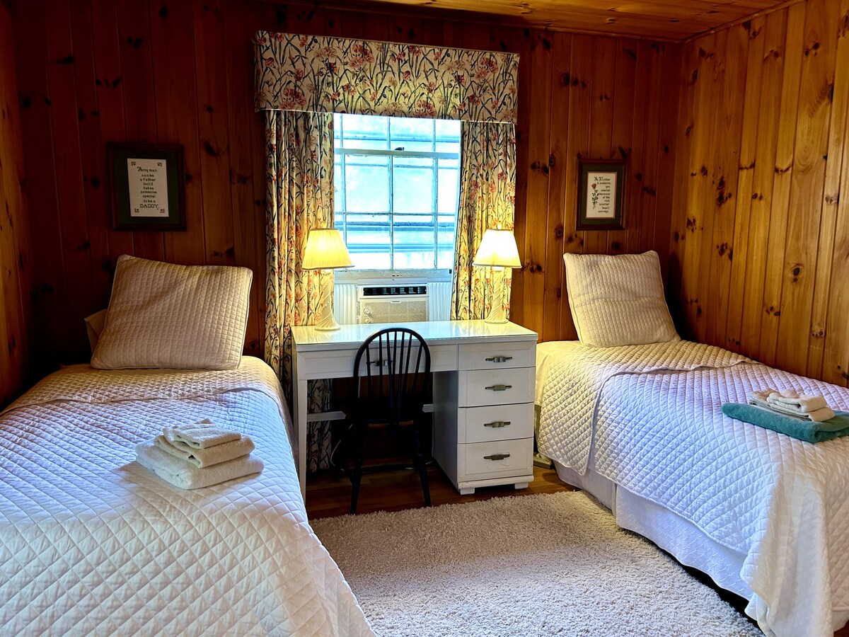 Downstairs bedroom, closet, dresser, desk space. Uses first floor guest bathroom. 