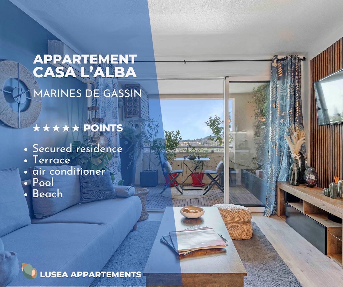 A spacious living area is depicted, featuring large glass sliding doors that open to a terrace with views of the outdoors. Comfortable seating is provided, alongside a stylish coffee table, while decor adds a touch of elegance. Natural light enhances the inviting atmosphere.