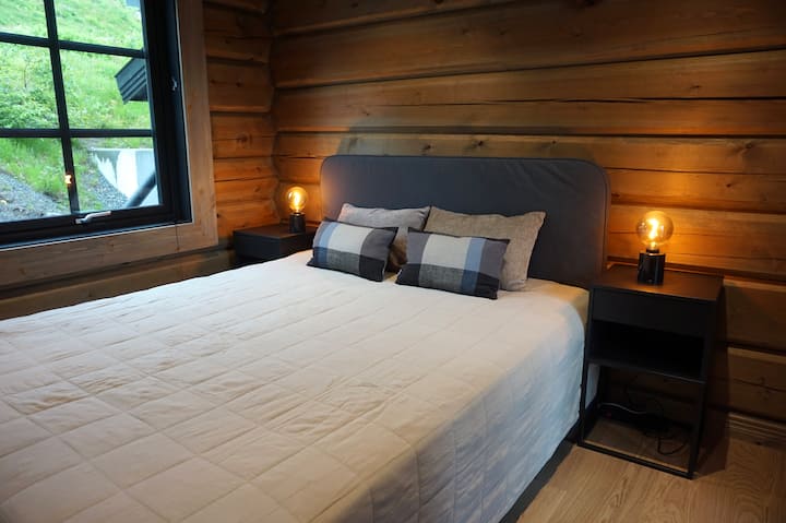 Bedroom 3: Cozy and stylish bedroom with soft lighting, plush bedding, and a serene view of the surrounding nature - perfect for a restful night in the mountains.