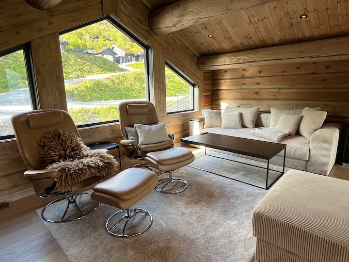 The spacious gallery loft offers two super comfy Stressless armchairs, a cozy sleeping sofa, a large TV, and a dedicated desk area, overlooking the main living room with its 6m high windows.