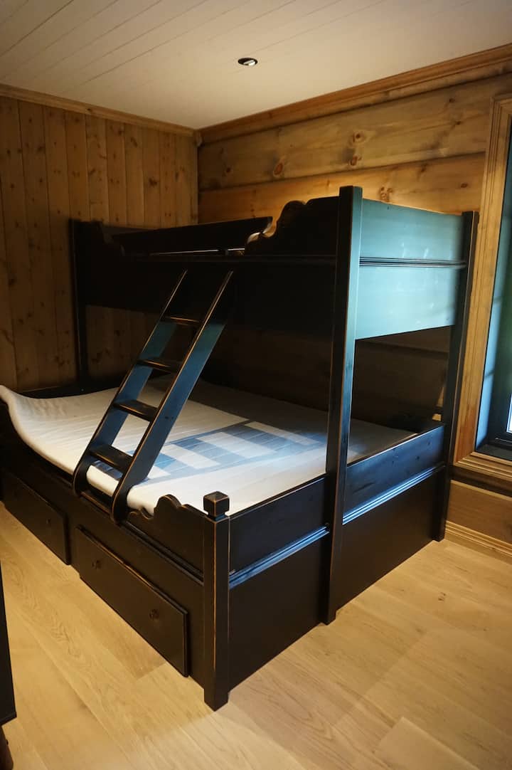 Bedroom 5 is perfect for kids, featuring a charming wooden bunk bed that sleeps up to 3 guests - cozy, practical, and full of cabin character.