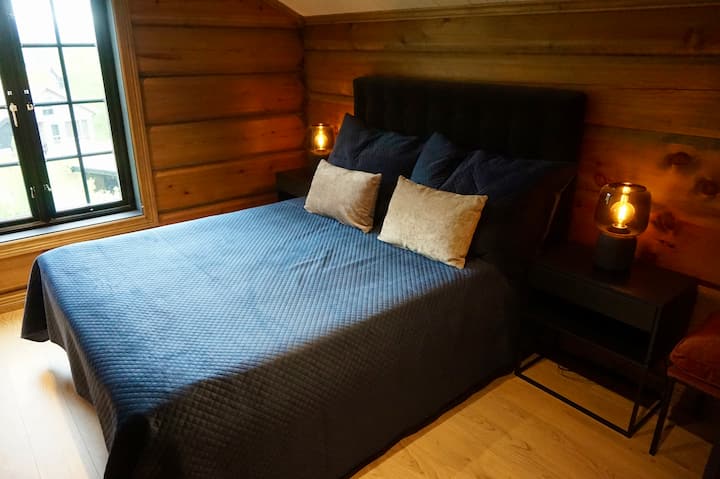 Bedroom 2: offers a stunning view and a soothing ambiance, with a plush bed, rich textiles, and Sonos smart lamps to set the perfect mood - ideal for lazy mornings and restful nights.