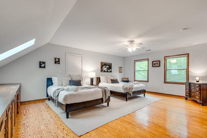 Bedroom 5 offers plenty of space and comfort with two queen-size beds, cozy bedding, and natural light — perfect for families or friends to relax and recharge together.