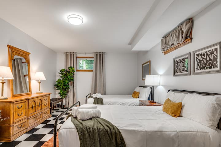 Bedroom 6 features two comfortable double beds, warm lighting, and stylish decor — a cozy retreat perfect for family or friends to relax and recharge after a fun day.