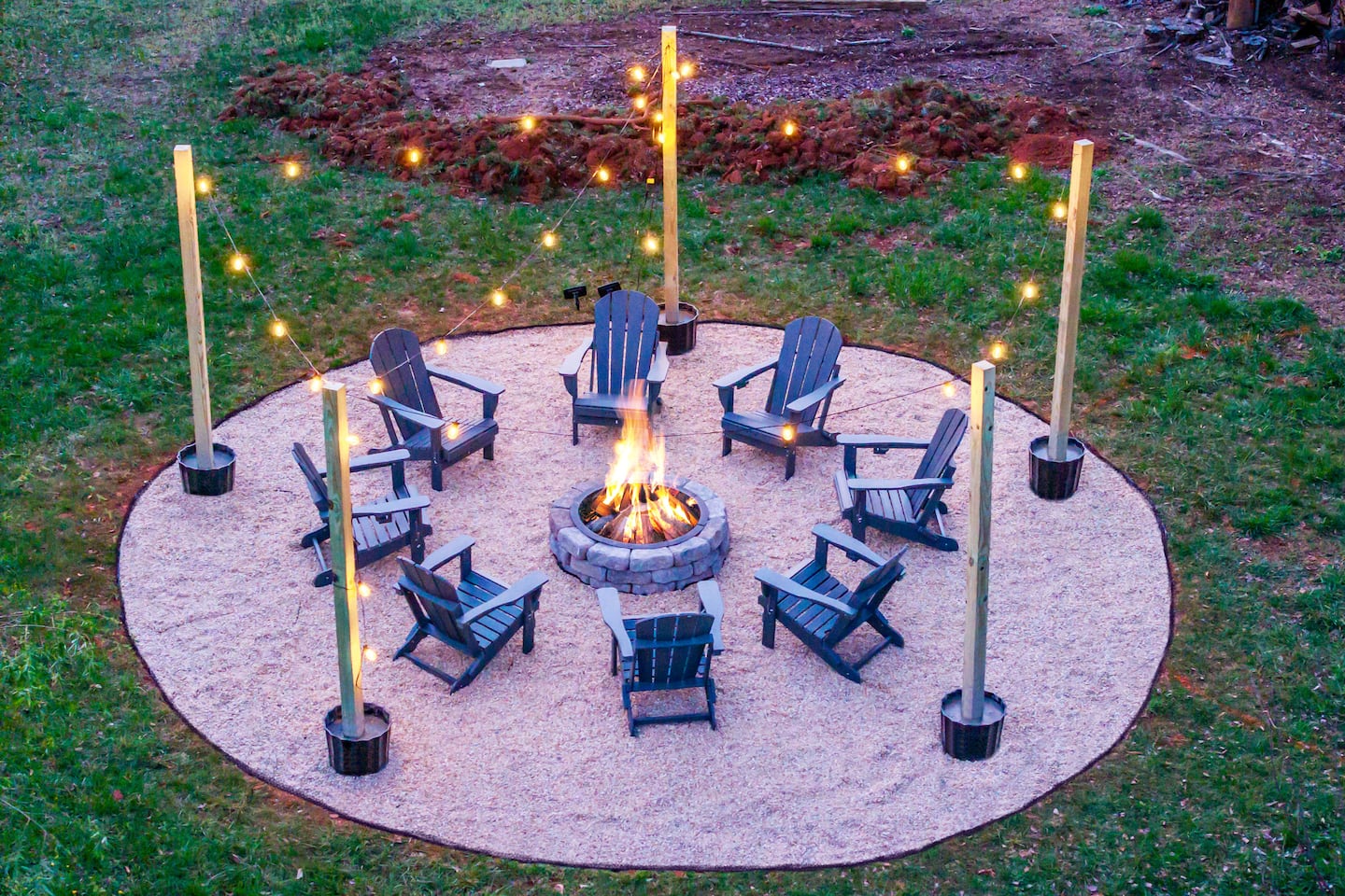 Photo 5 — Fire pit lit at dusk with string lights aglow