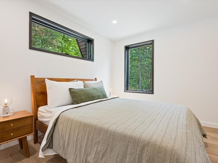 Main floor queen bed - ideal for a restful night or simply gazing out at the trees
