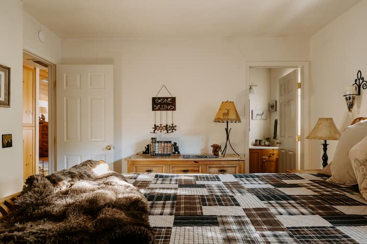 The sun shines through the pines early morning.  Attached full bath and Ca King bed.