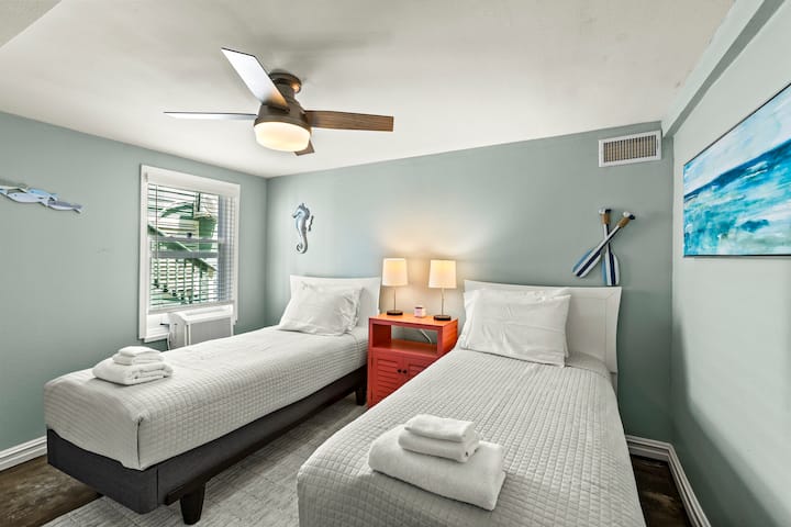 Cozy twin beds with easy access to kitchenette