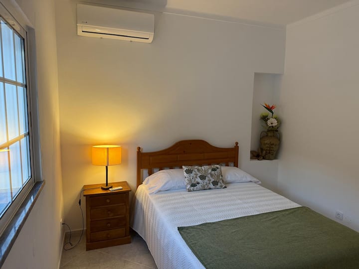 Cozy bedroom with double bed and wardrobe