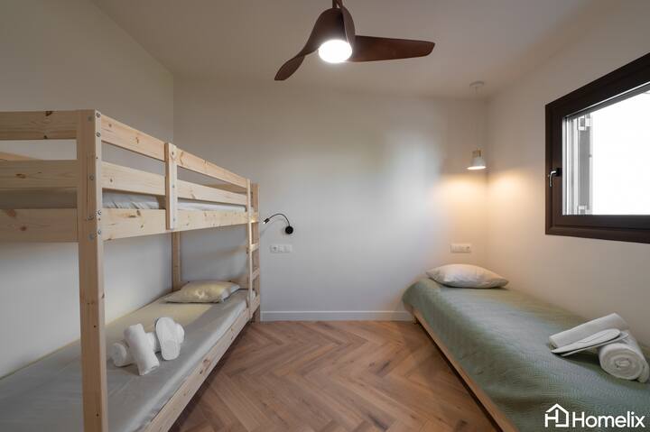 The 2nd bedroom with 1 bunk bed for 2 people as well as a bed that can be converted into 2 singles to accommodate 2 people.