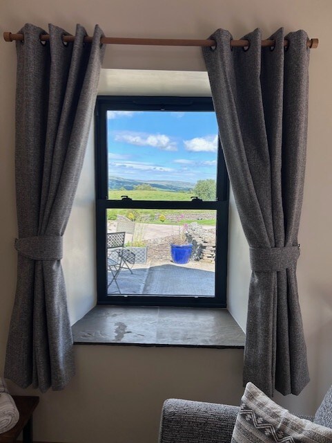 נוף לגבעות מחלון הטרקלין.  חלון זה משקיף על מקום החניה של האורחים ועל פינת האוכל של הביסטרו.