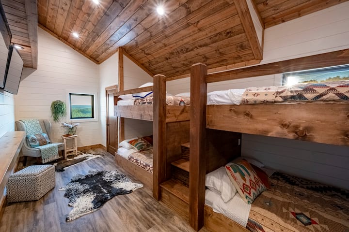 Bedroom with built-in wood bunk beds and cozy seating area