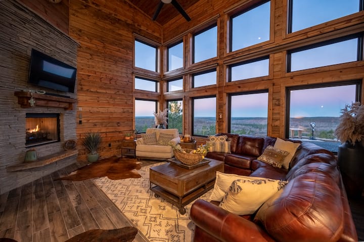 Rustic cabin living room with panoramic forest views