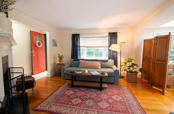 Cozy front sitting area with wood burning fireplace.