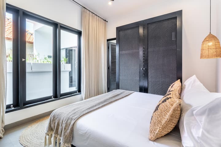 Room #2 on the second floor, features a queen bed, built-in wardrobe, and a private ensuite. It offers seamless access to a stylish secondary lounge—a cozy retreat perfect for movie nights, reading, or simply unwinding after a day of exploring Bali.