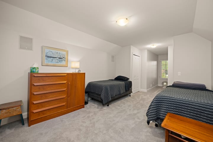 Тази уютна спалня на горния етаж разполага с две удобни единични легла с чисто ново спално бельо, меко осветление и лесен достъп до обща баня.Това е спокойно място, идеално за деца или за самостоятелни пътешественици, които искат да се отпуснат и да се презаредят.