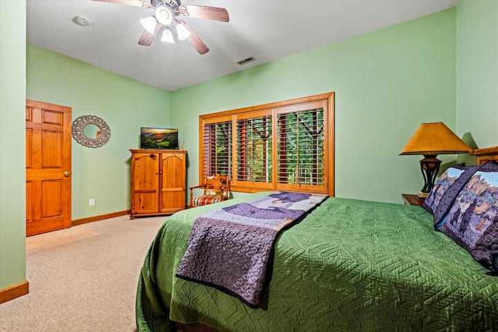 Bedroom #3, basement: Featuring a queen bed. There's an attached full bathroom 