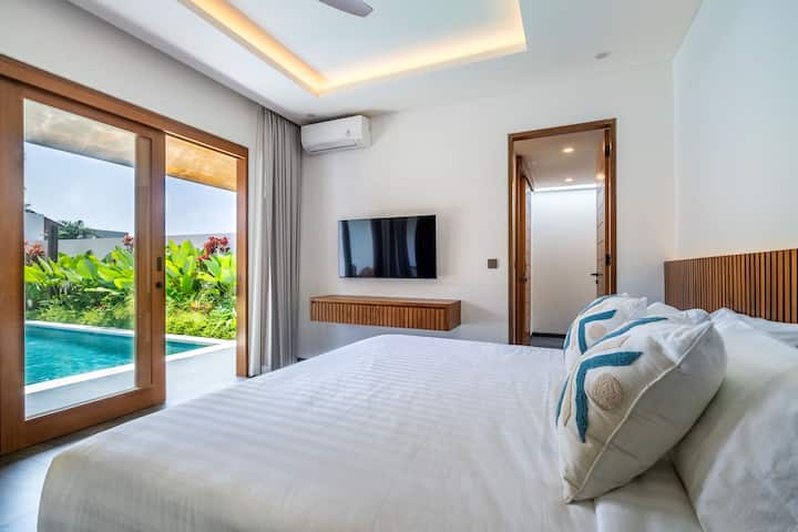 Villa Domus B4-ის მთავარი საძინებელი გთავაზობთ ფართო სუპერ დიდ საწოლს, ტელევიზორს, სააბაზანოსა და კომფორტულ დივანს, საიდანაც პირდაპირ იშლება აუზი და აყვავებული ბაღი