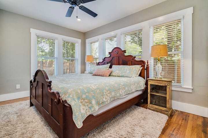 Cómoda cama tamaño king con edredón de plumas en el dormitorio delantero con ventilador de techo, luces de techo regulables y lámparas de lectura.