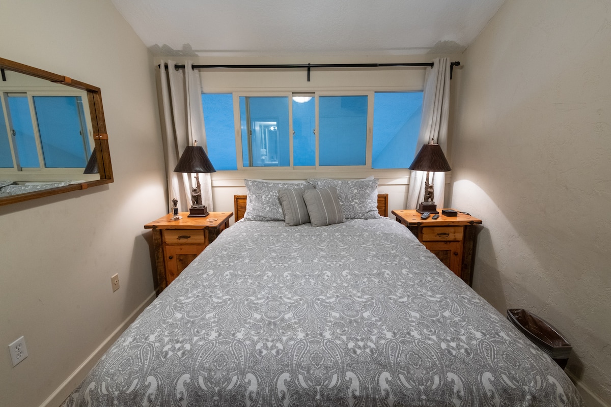 Elegantly simple master bedroom setup, providing a serene end to a day in the mountains.
