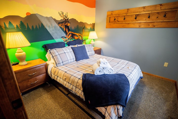 This bedroom is located downstairs, featuring a queen bed and ceiling fan. Check out our SWEET murals - Hand-painted by the fabulous Andy Bablo from Steez Design. His work is all over New Hampshire and Massachusetts.