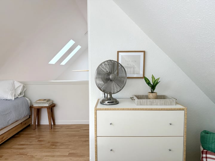 This lofted bedroom is spacious and airy.
