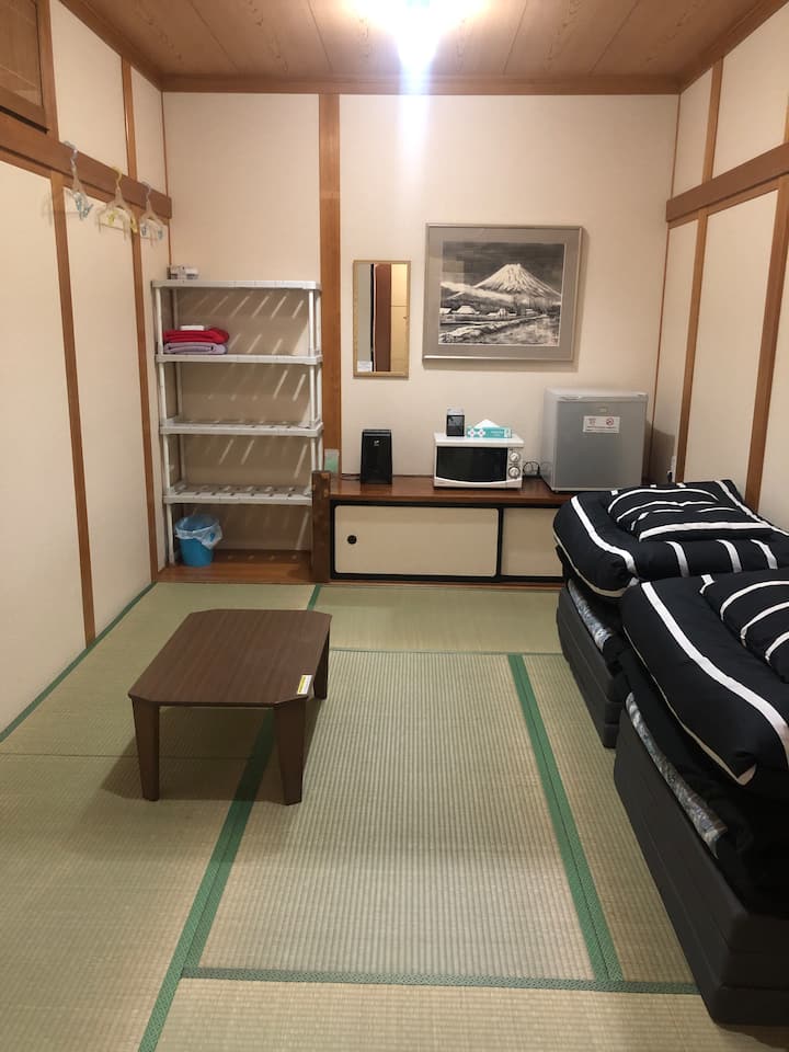 Japanese-style Private Room "A" is designed to accommodate 1-3 guests. It includes a small refrigerator and microwave oven. Bath Towels, Face Towels, and Toothbrush sets are provided.