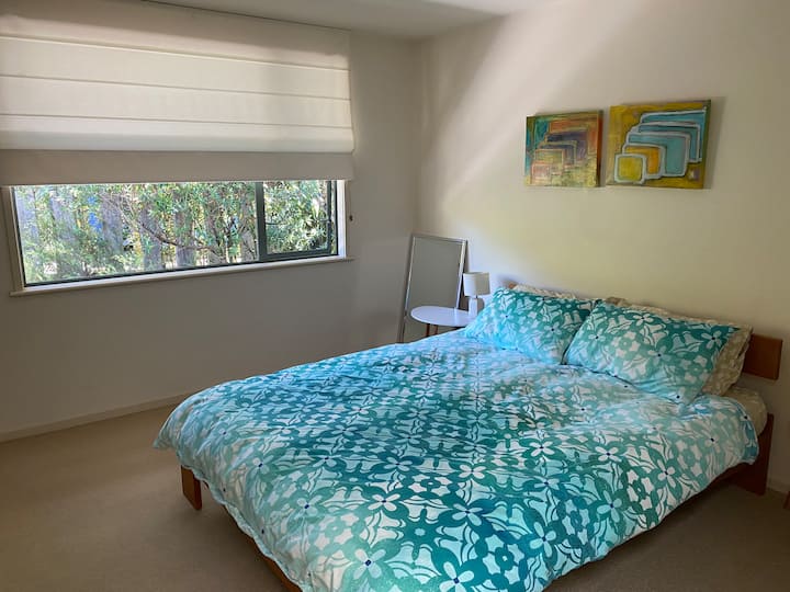 Comfy queen bed with 100% cotton linens and extra pillows for a good night's sleep