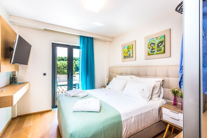 First Level: Bedroom 3 with double bed and private patio area