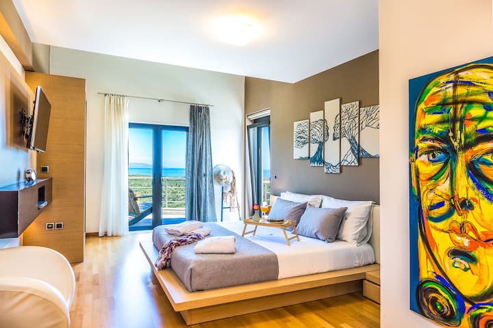 Second Level: Master suite with en-suite bathroom, walk-in wardrobe and private balcony with sea view.