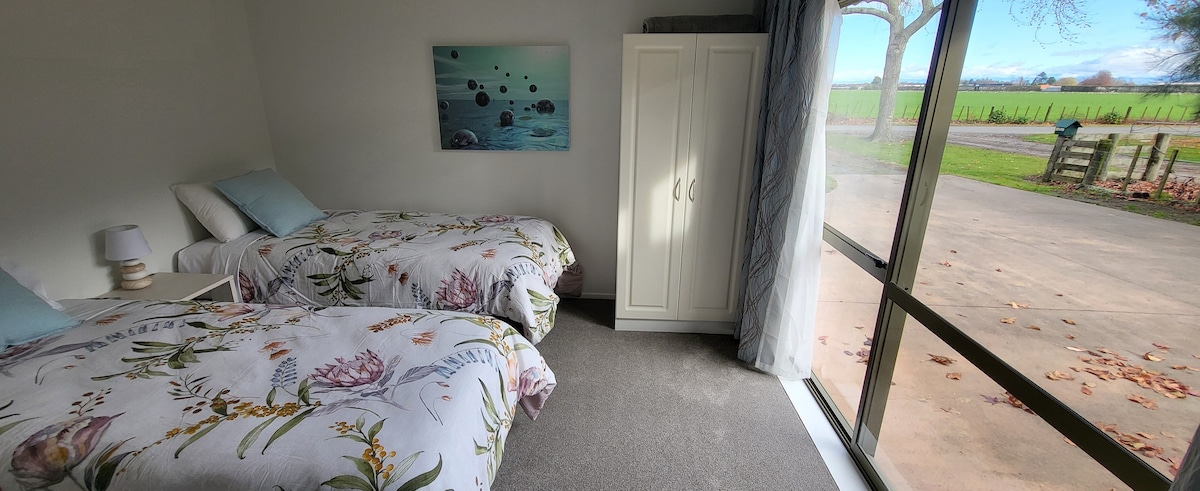  This room gets the most sun and best sunset views. 
The two single electric beds can be made up as a  Super King bed.
It is directly across passage from shower bathroom