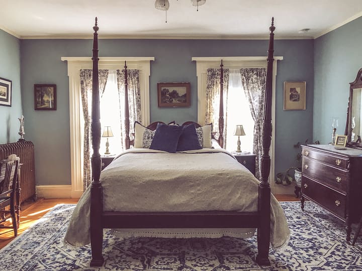 The Cragin Room has three bedroom windows overlooking the Colchester Town Green and Memorial Green, a small closet, blackout curtains, private bath with standup shower, and a lockable hallway that connects to the Smith Room next door.