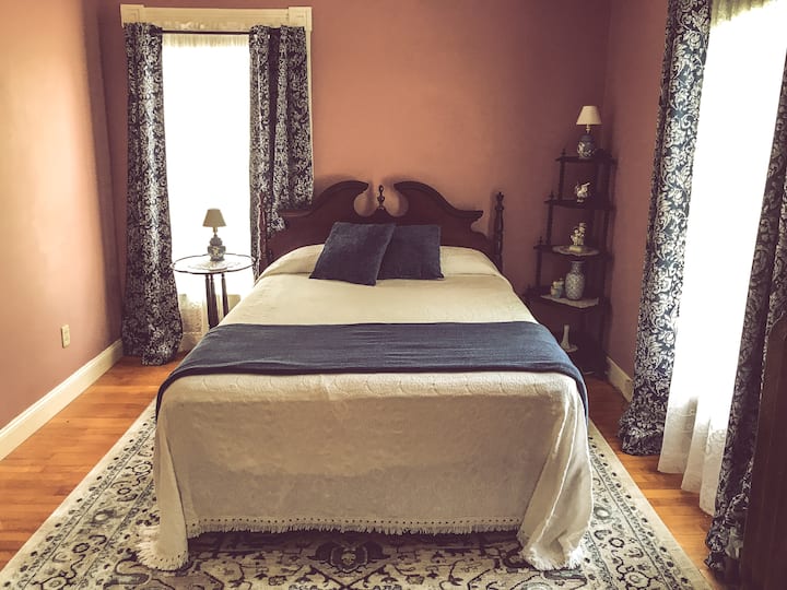 The Smith Room has 5 windows including a cozy bay overlooking the Town Green. It has a queen bed, sleeper sofa, walk-in closet, electric fireplace, private full bath with jetted tub, and a lockable hallway that connects to the Cragin Room next door.