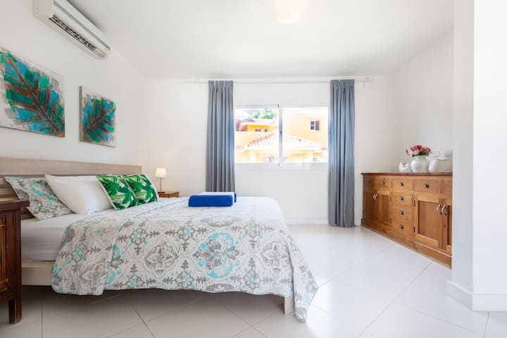 Enjoy a comfortable bedroom featuring a spacious wardrobe, air conditioning, and an en-suite bathroom.
