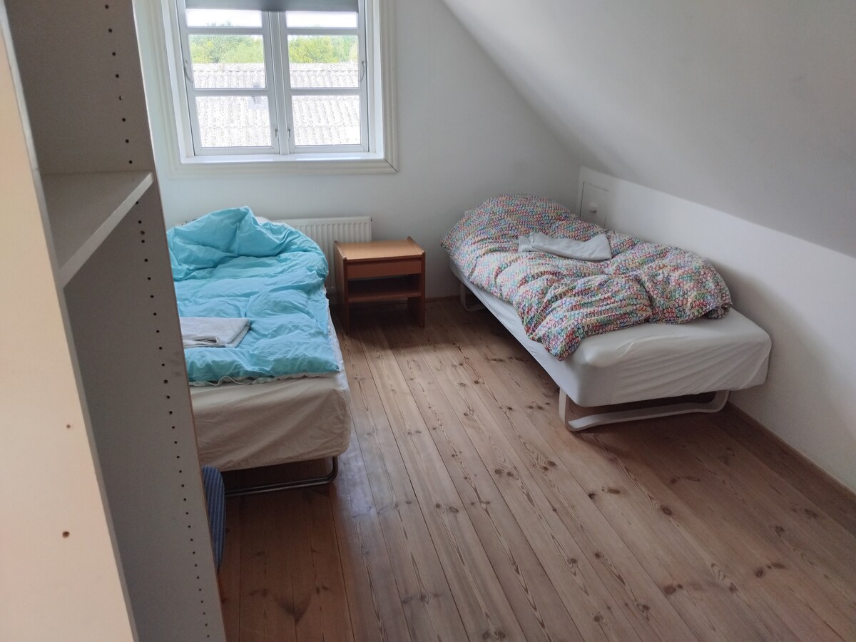Twin bedroom, workspace, larger closet for storing clothes. The room is like the other three rooms on the first floor with its own table and chairs, suitable as a secluded working room during the daytime if the family joins.