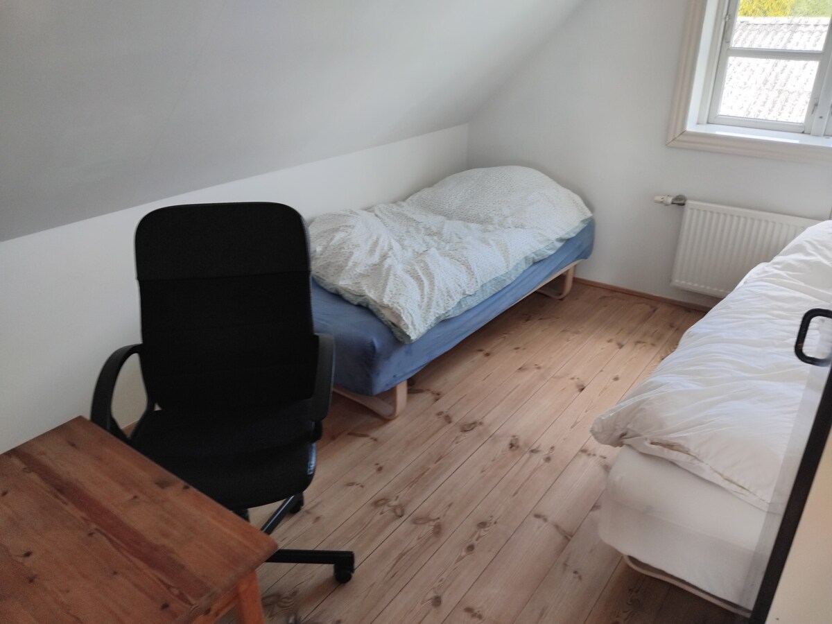 Twin bedroom, workspace, larger closet for storing clothes. The room is like the other three rooms on the first floor with its own table and chairs, suitable as a secluded working room during the daytime if the family joins.