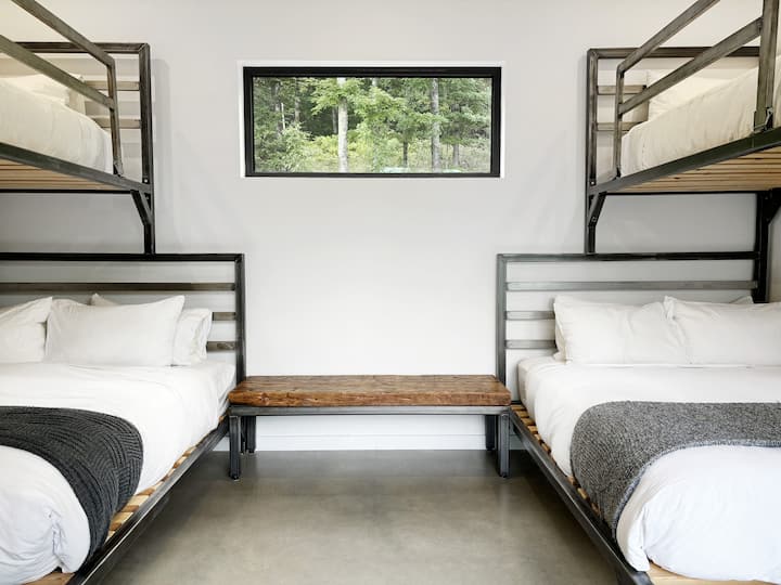 Bunk Room: Stylish bunk beds invite fun sleepovers, enhanced by serene woodland views!