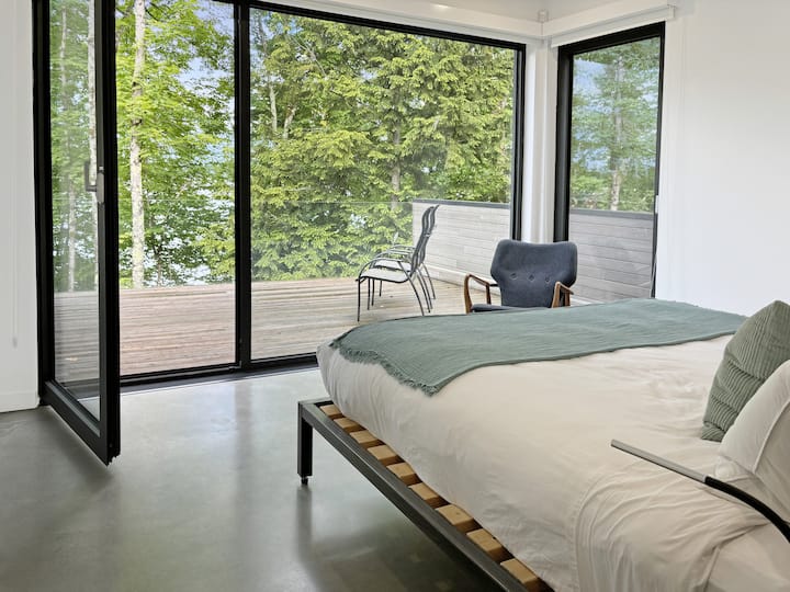 Master Bedroom 2: Bright retreat featuring a king bed, stunning views, a private terrace and ensuite bathroom.