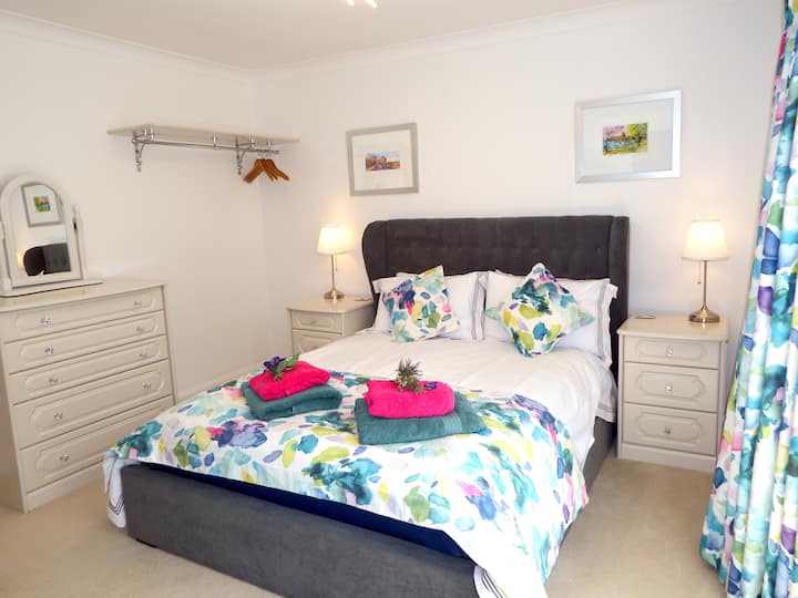 Kitanda chenye ukubwa wa kifalme chenye nafasi kubwa. Reli inayoning 'inia hutolewa kwa ajili ya ufikiaji wa haraka wa nguo zako wakati wa ukaaji wa muda mfupi, au kabati la nguo linaloingia linapatikana kwa ajili ya wakati unakaa muda mrefu kidogo.