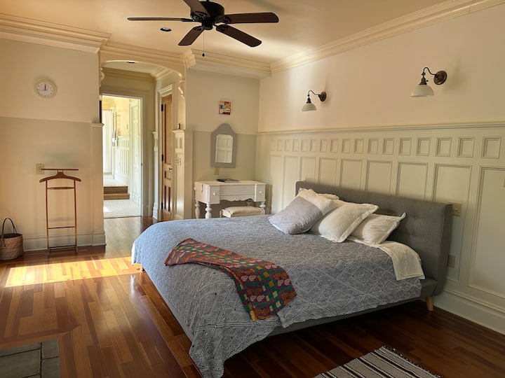 King size bed in main bedroom, with a small balcony overlooking the creek. No blinds.