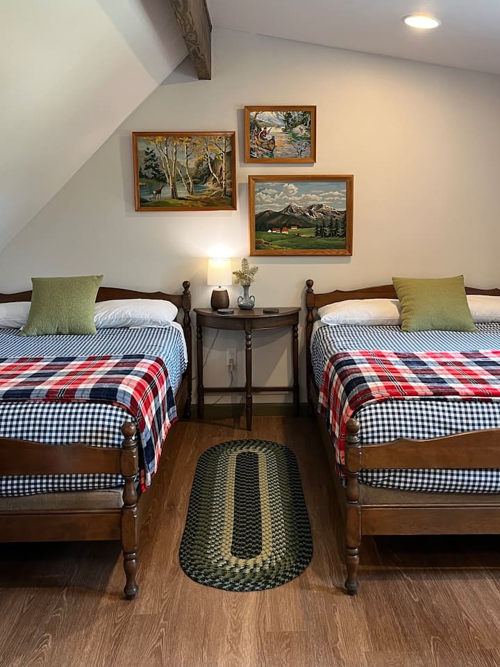 Two full size beds in the second story loft of the "Haw" side.