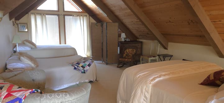 Eagles Nest Loft Bedroom upstairs.  1 Queen bed, 2 Full beds and 1 child's pack and play crib. Open loft with privacy screen.