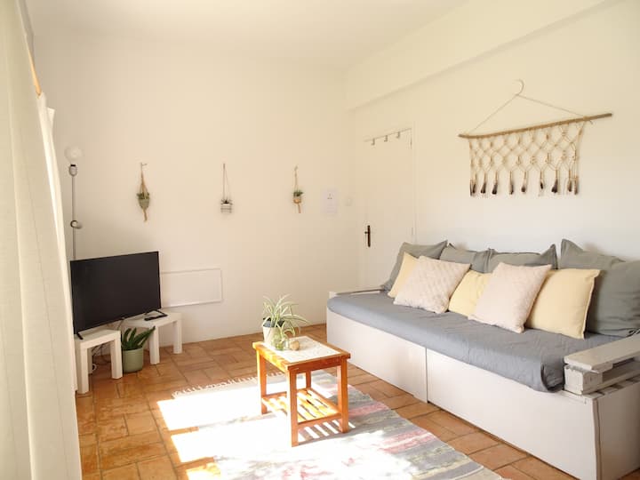 Oliveira Suite's bright and charming living room overlooks large windows with views of the garden and plenty of natural light. Enjoy a comfortable sofa (can be converted to a single bed) and a Smart TV.