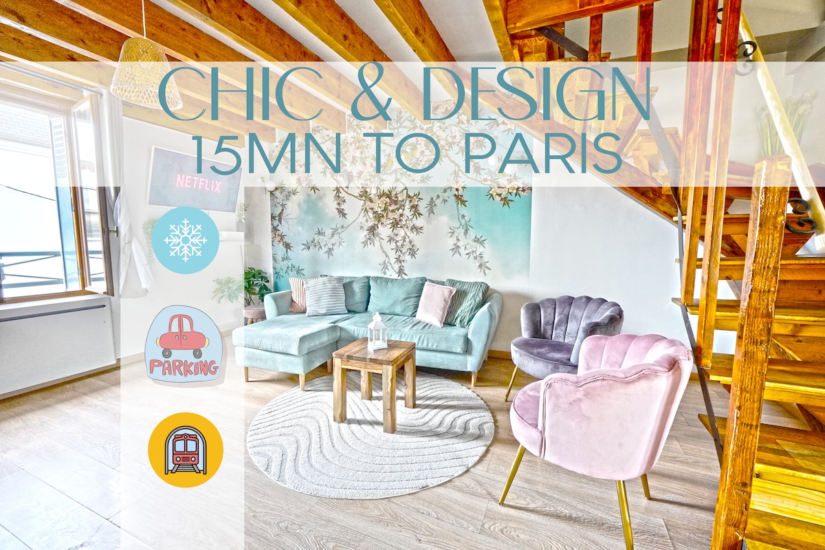 A modern living area is highlighted by a soft color palette, featuring a light blue and pink velvet sofa set. A round wooden table occupies the center, while a decorative rug adds warmth to the wooden floor. Natural light floods in from a nearby window.