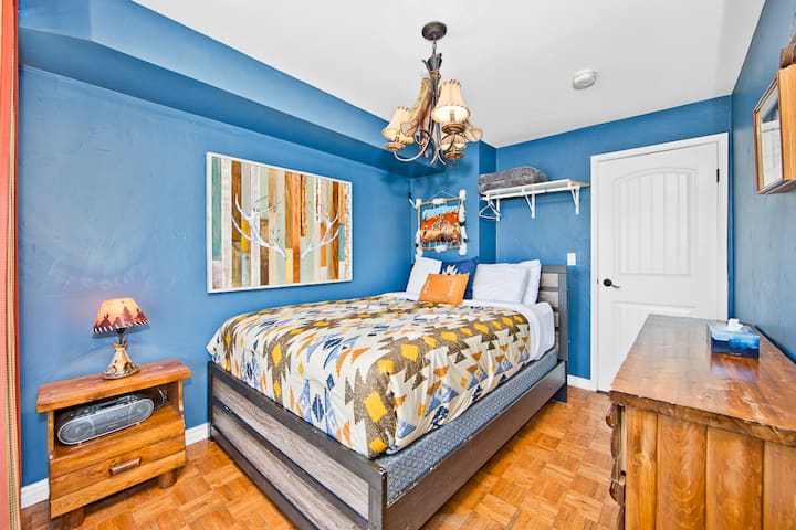 Main floor of the home - third bedroom with a queen sized bed. Direct access to the deck 