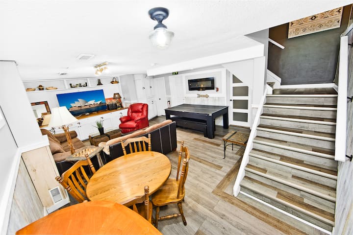 Lower rec room - 4 seater table, Love seat and queen sofa bed, big screen TV and pool/ping pong table, 