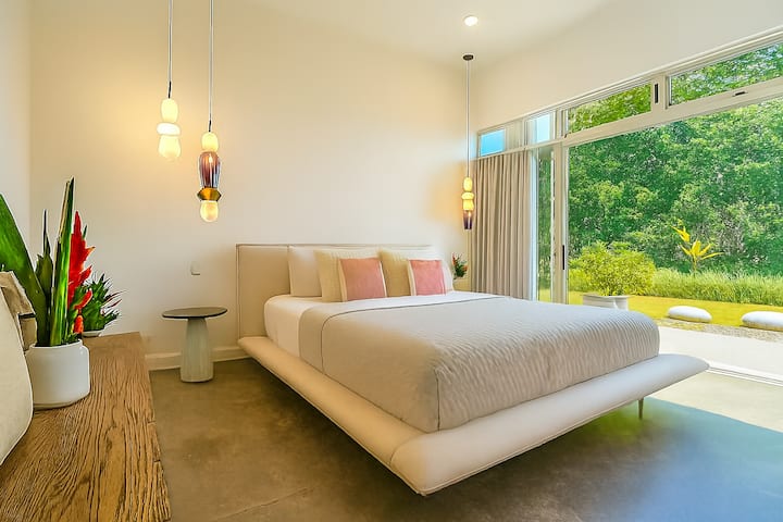 Beautiful, quiet, and private second bedroom with a plush comfortable bed, air conditioning, tranquil jungle views, and its own adjacent full bathroom—perfect for rest and relaxation.